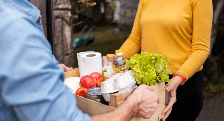 Someone Giving Groceries To A Friend