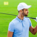 Man In Golf Outfit Holding Club