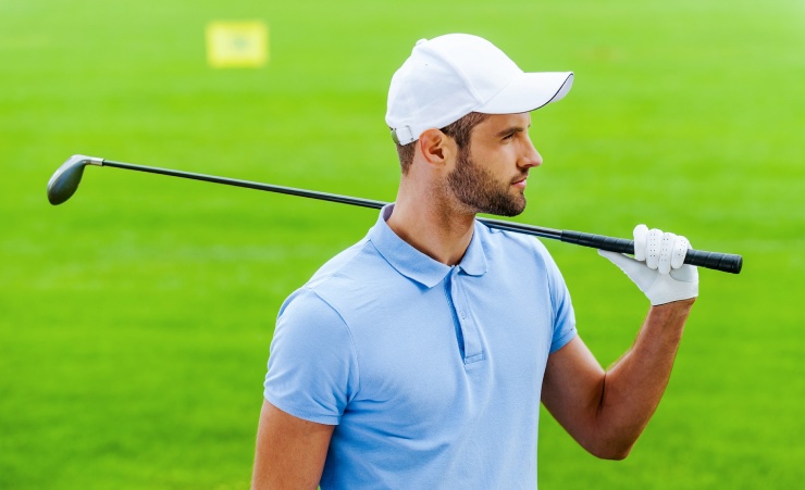 Man In Golf Outfit Holding Club