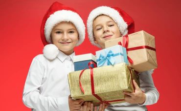 Boys Holding Christmas Gifts Smiling