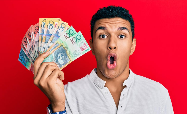 Man Holding Up Australian Dollars