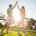 Man Woman High Five On Golf Course
