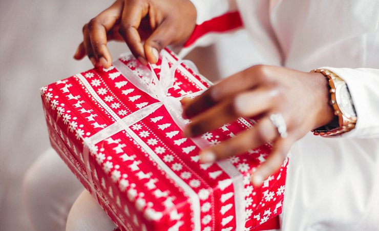 Person Opening A Christmas Present