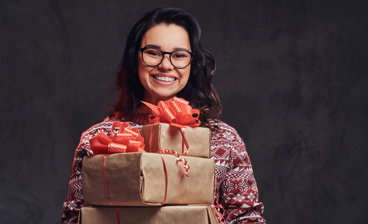 Woman Holding Many Christmas Gifts