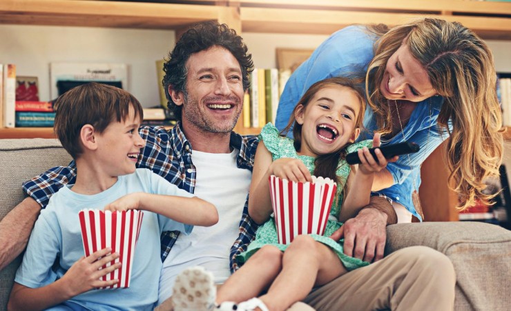 Dad and family laughing watching a movie