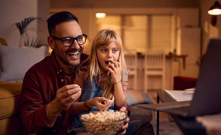 Father And Daughter Watch Movie On Laptop