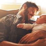 Father Looking At Baby Sitting