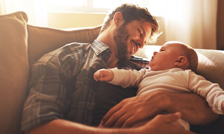Father Looking At Baby Sitting