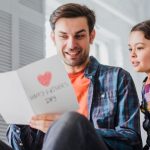 Father Reading Card From Child