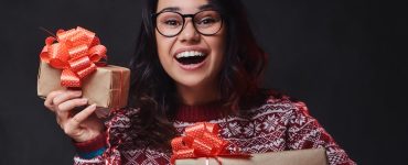 Woman Holding Christmas Gifts And Smilinig