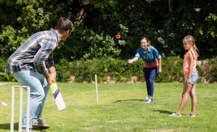 Family Playing Backyard Cricket