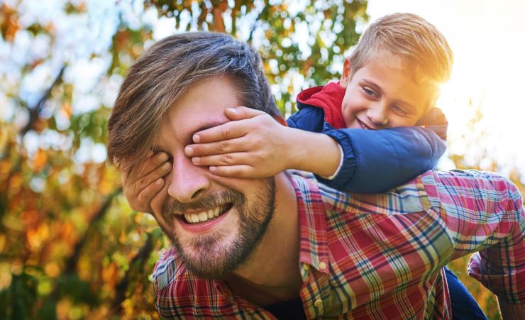 Son Holding Dads Eyes Walking