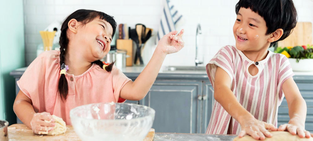 two girls baking cake