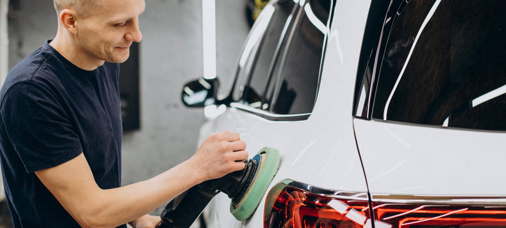 man buffing car