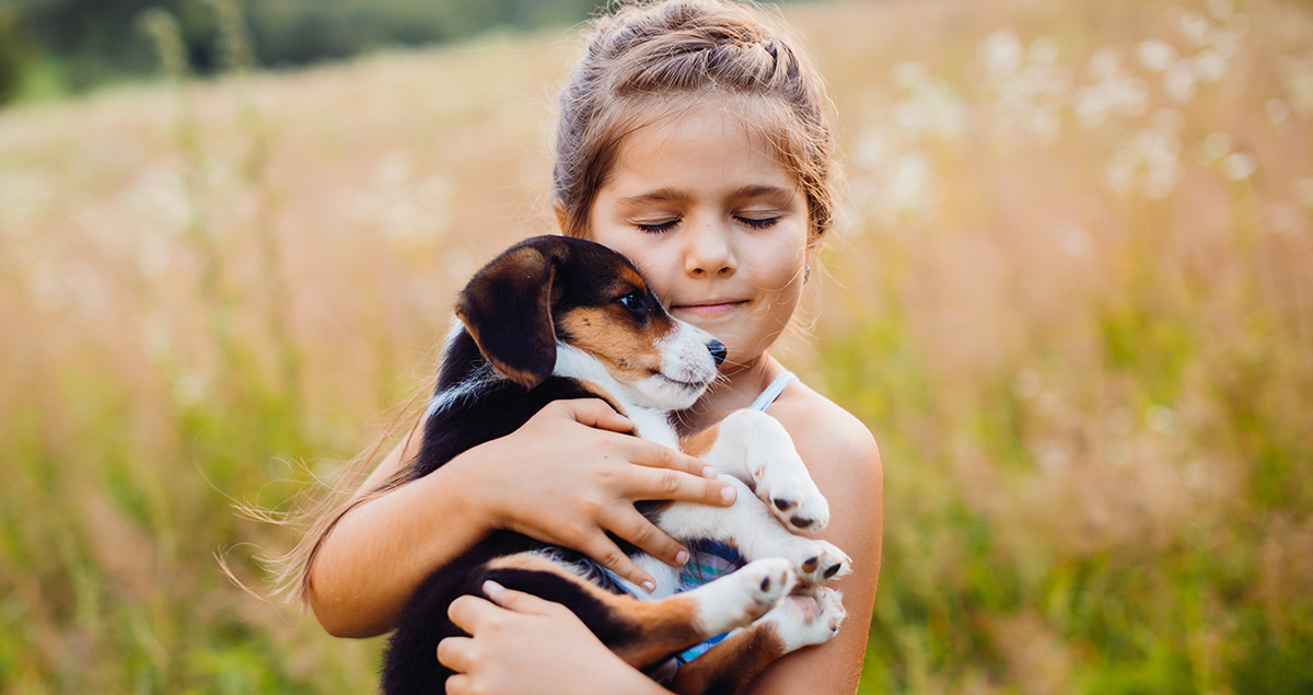 Little Girl Hugging Puppy